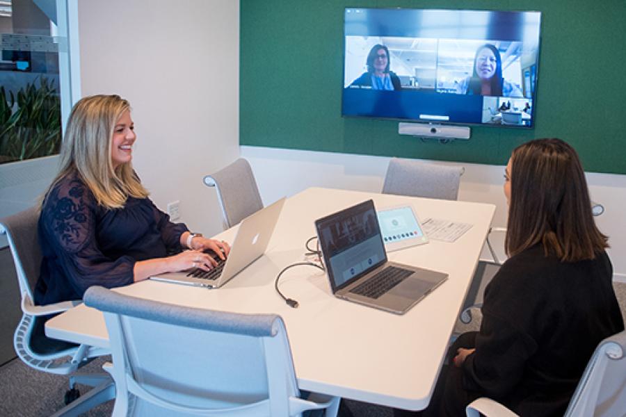 Two people using a conference room at Stanford Redwood City