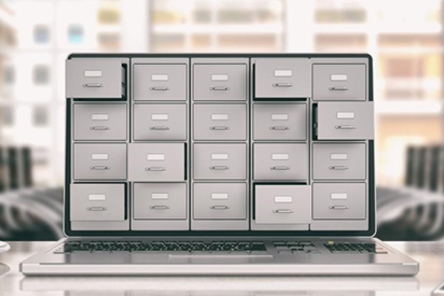 Image of laptop with file cabinet drawers on it