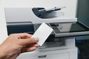 Image of person using badge to print