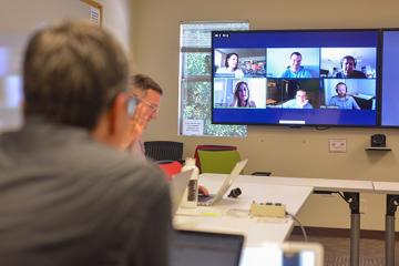 Image of people in video conferencing room