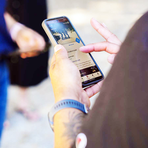 person using Stanford Mobile app while on an art tour